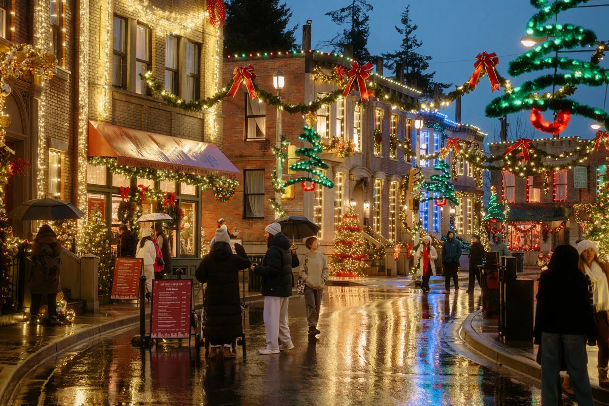 Guests explore the beautifully decorated streets of Merry & Bright at Martini Town, featuring sparkling Christmas lights, festive garlands, and holiday displays.
